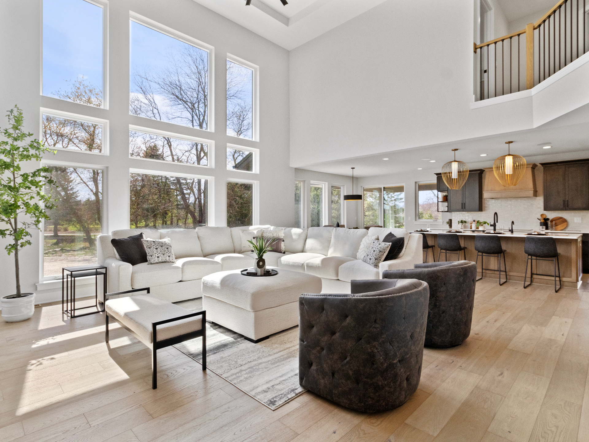 Sunlit luxury living room with floor-to-ceiling windows and modern interior design